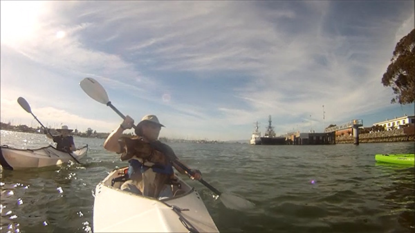 Person paddling a kayak with a dog